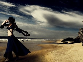 woman dancing alone on beach