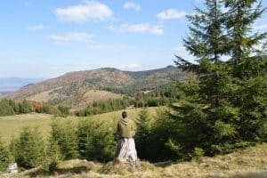 man sitting meditating in nature