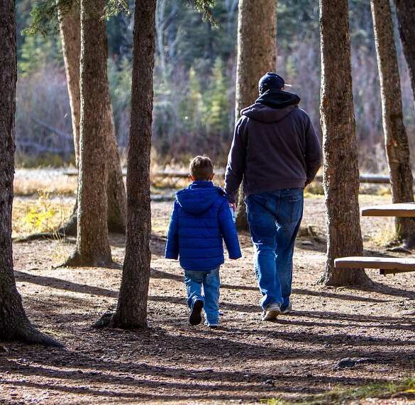 Father and young son walking outdoors