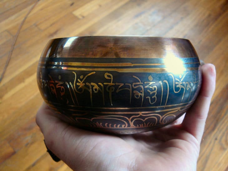 Holding Tibetan singing bowl in hand