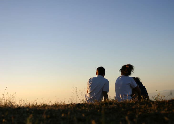 two people in conversation at sunset