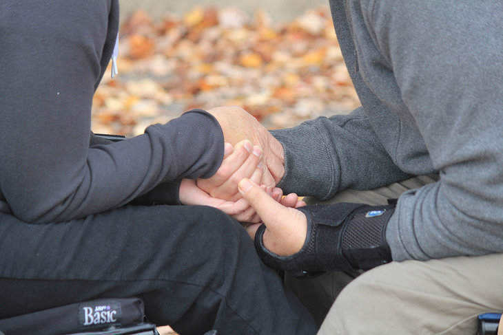close up of man and woman - holding hands