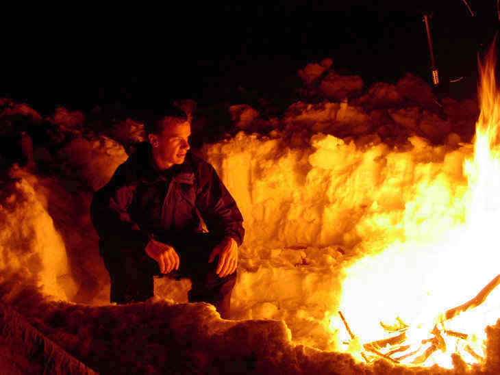 man in front of fire