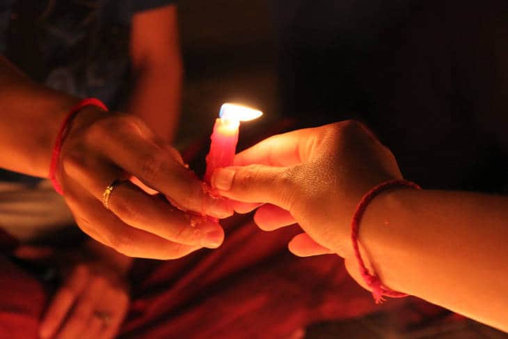 Joining hands with candle - Time for change