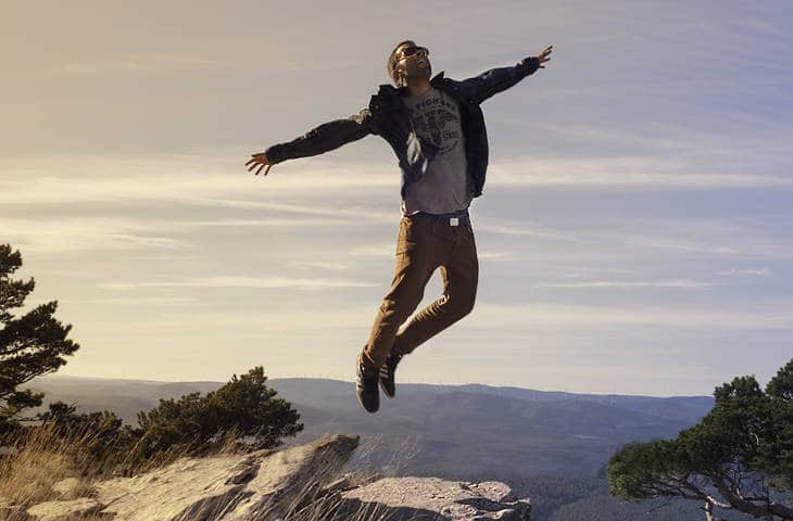 Young man jumping on rock - Age Ain't Nothing but a Number