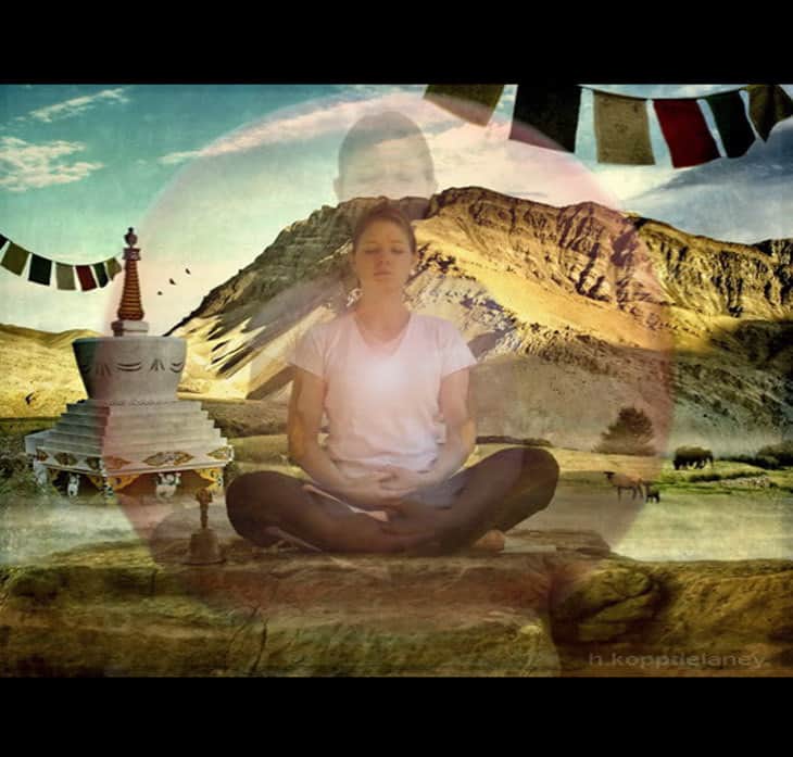 Meditator meditating among mountains