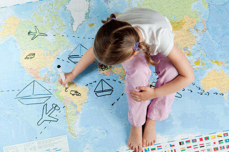 OBSERVATION AND CURIOSITY: Mindful travel through the eyes of a child 13 Child sitting on map