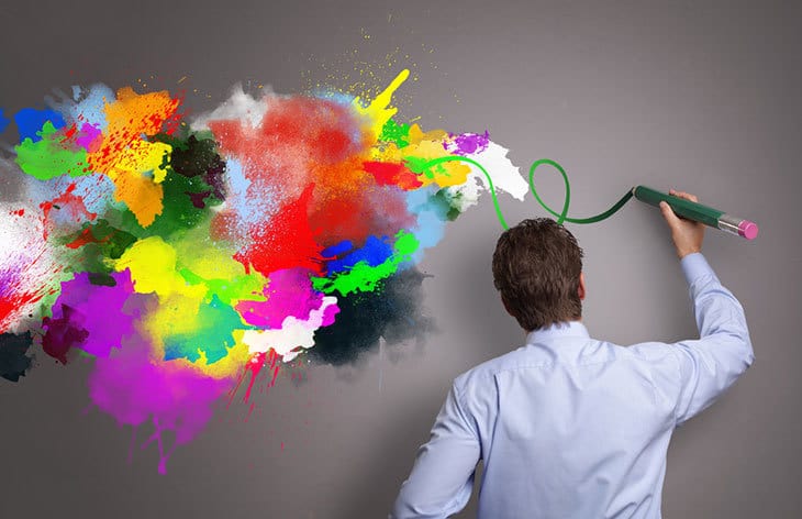 Man drawing colours on wall