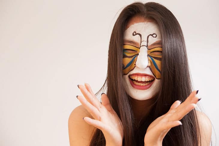 Happy, healthy face smiling with butterfly paint