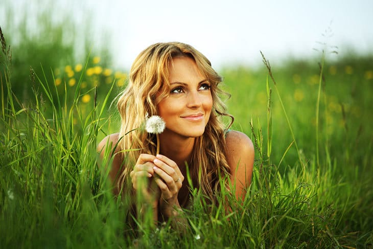 Beautiful woman lying in a field