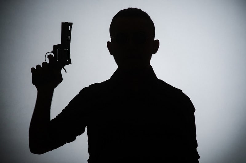 Silhouette of man with gun