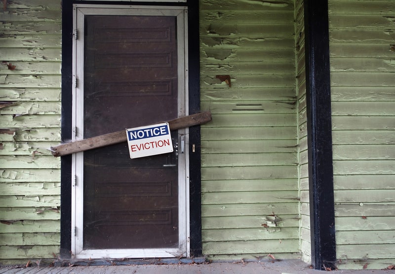 old house with eviction notice on door