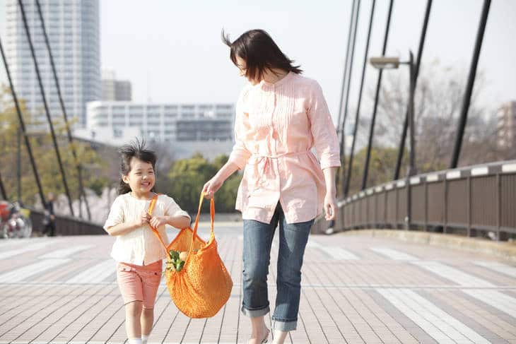 Mother and daughter with reusable shopping bag - Designing a sustainable lifestyle