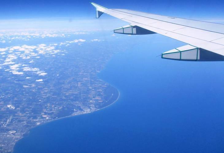 Airplane flying over land - The world that is there for us