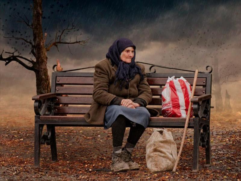 Old woman sitting on bench with shopping bags