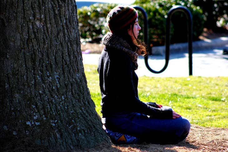 MINDFUL BREATHING: Exploring why it's the core element of meditation 13 Young woman meditating beside tree trunk - Mindful breathing