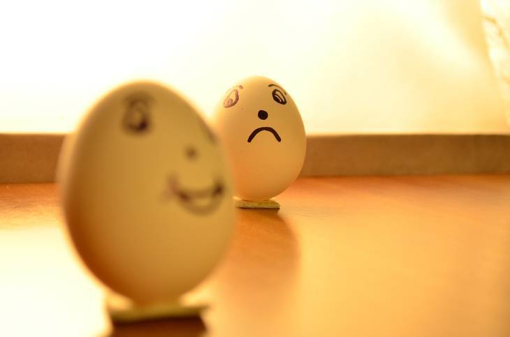 Egg with happy face and egg with sad face - Acceptance of negativity