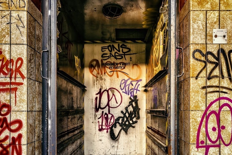 Elevator in abandoned building covered in grafiti
