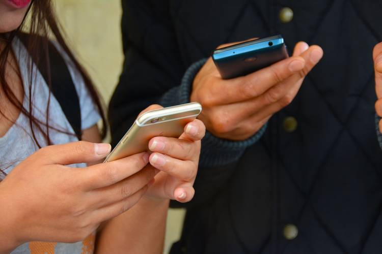 Two people using smartphones - Down the Trail