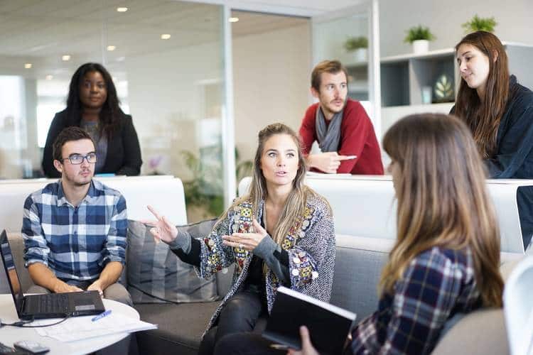 Coworkers talking in office - It's all one world