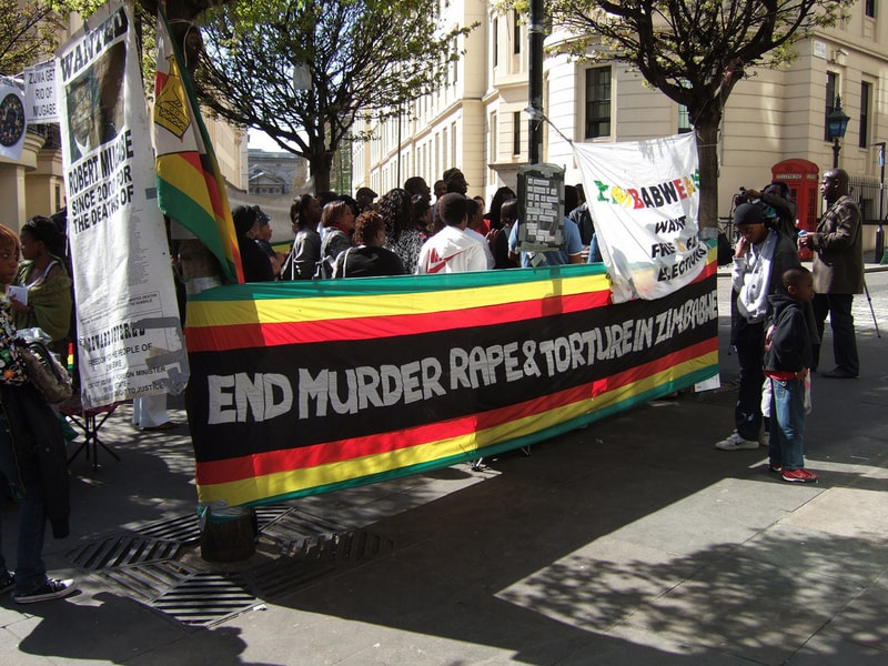 protesters in Zimbabwe with banner