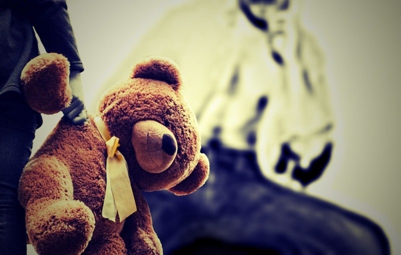 child carrying a teddybear