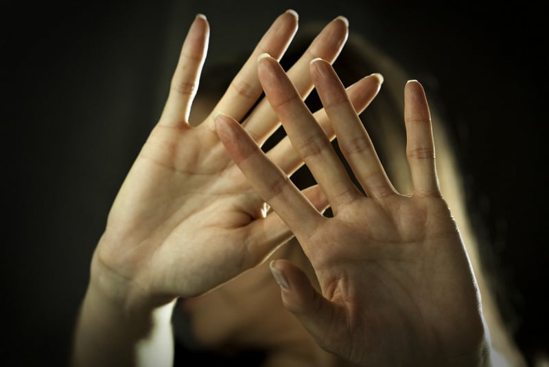 Woman looking through her hands