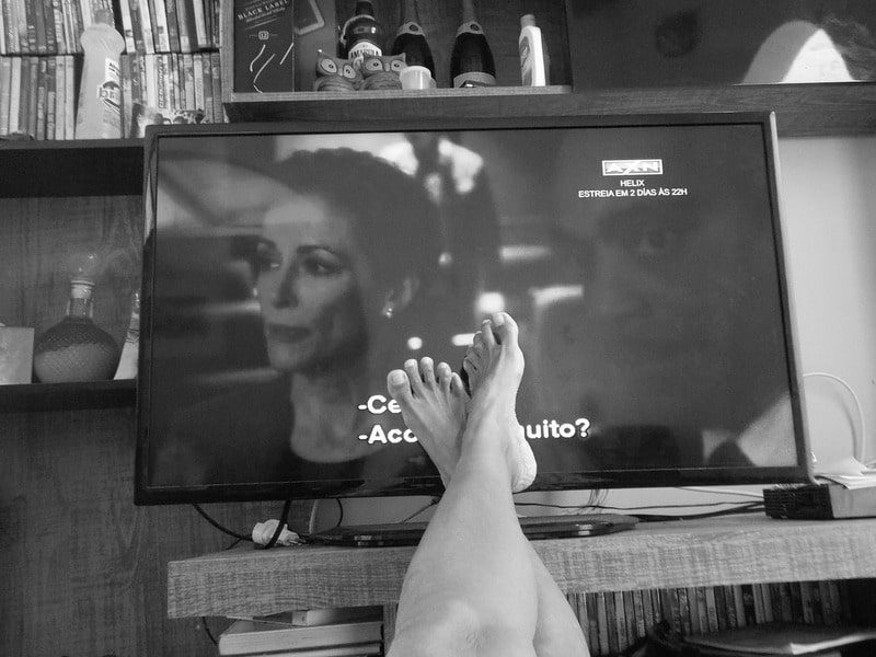 woman's feet in front of TV