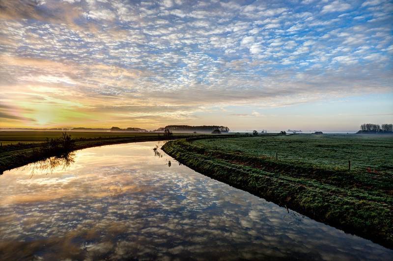 Still river with reflection of clouds going through meadow - Finding me