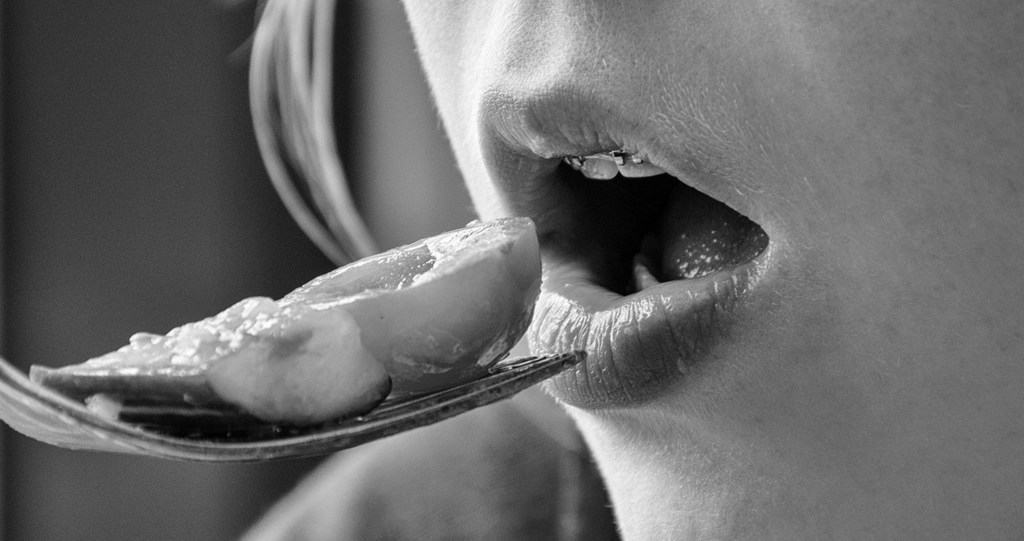 THE SCIENCE BEHIND MINDFUL EATING: How to make healthy choices when internal cues lead you astray 13 black and white photo of woman eating a bite of food