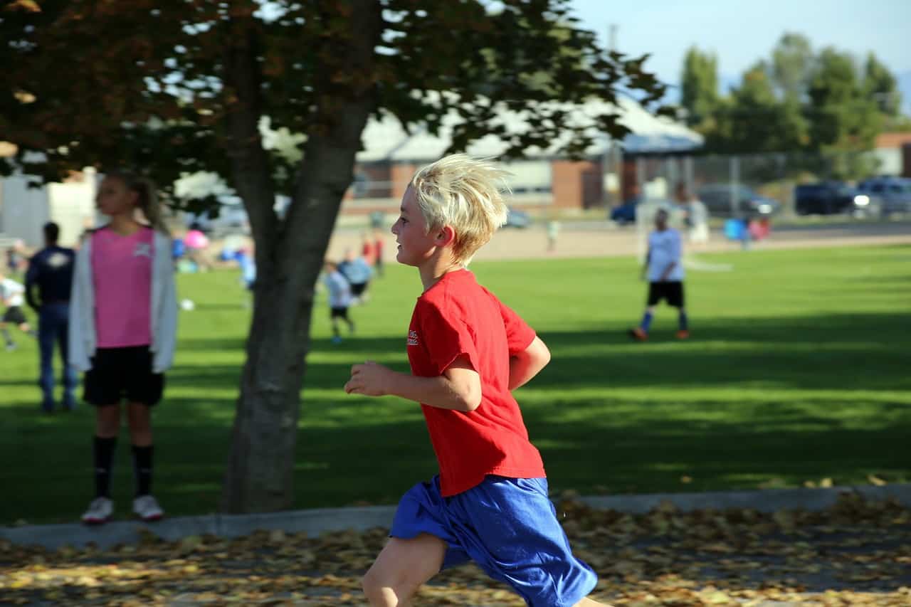 Young boy running through playground - Different is good