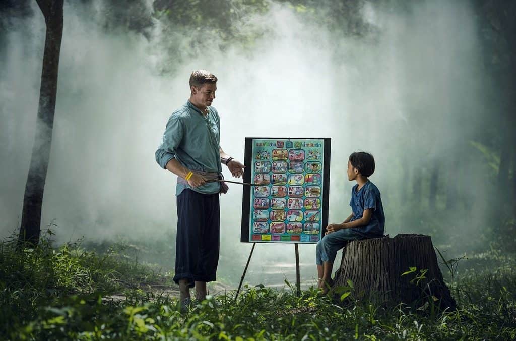 teacher outdoors with student