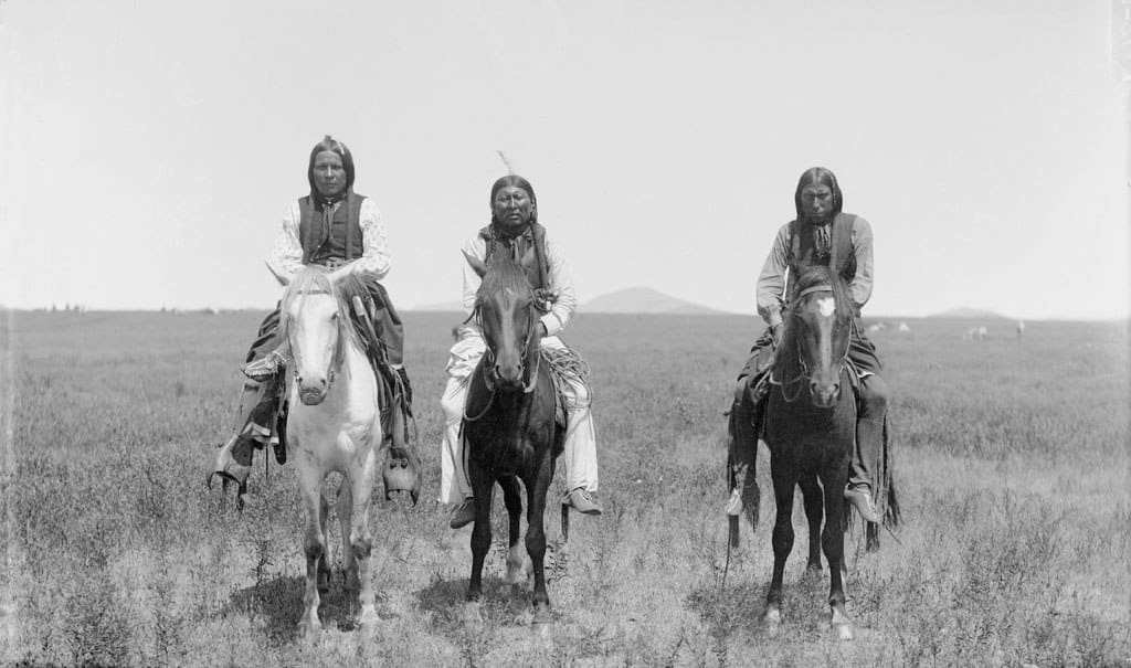 Three Comanche warriors on horseback - News of the World