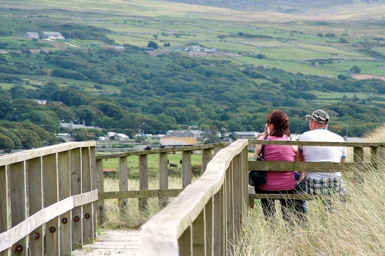 Married couple sitting on bench overlooking countryside - The 5 love languages