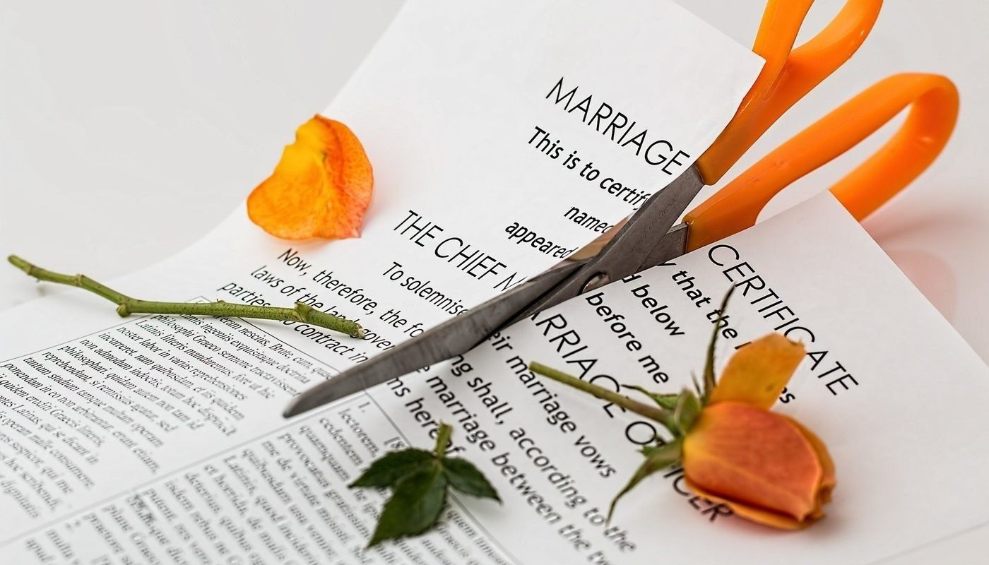 scissors cutting marriage certificate