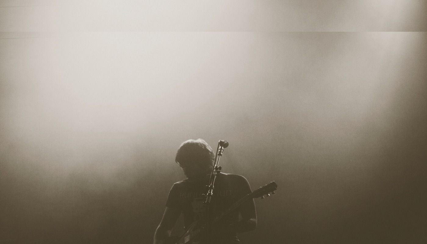 man tuning his guitar