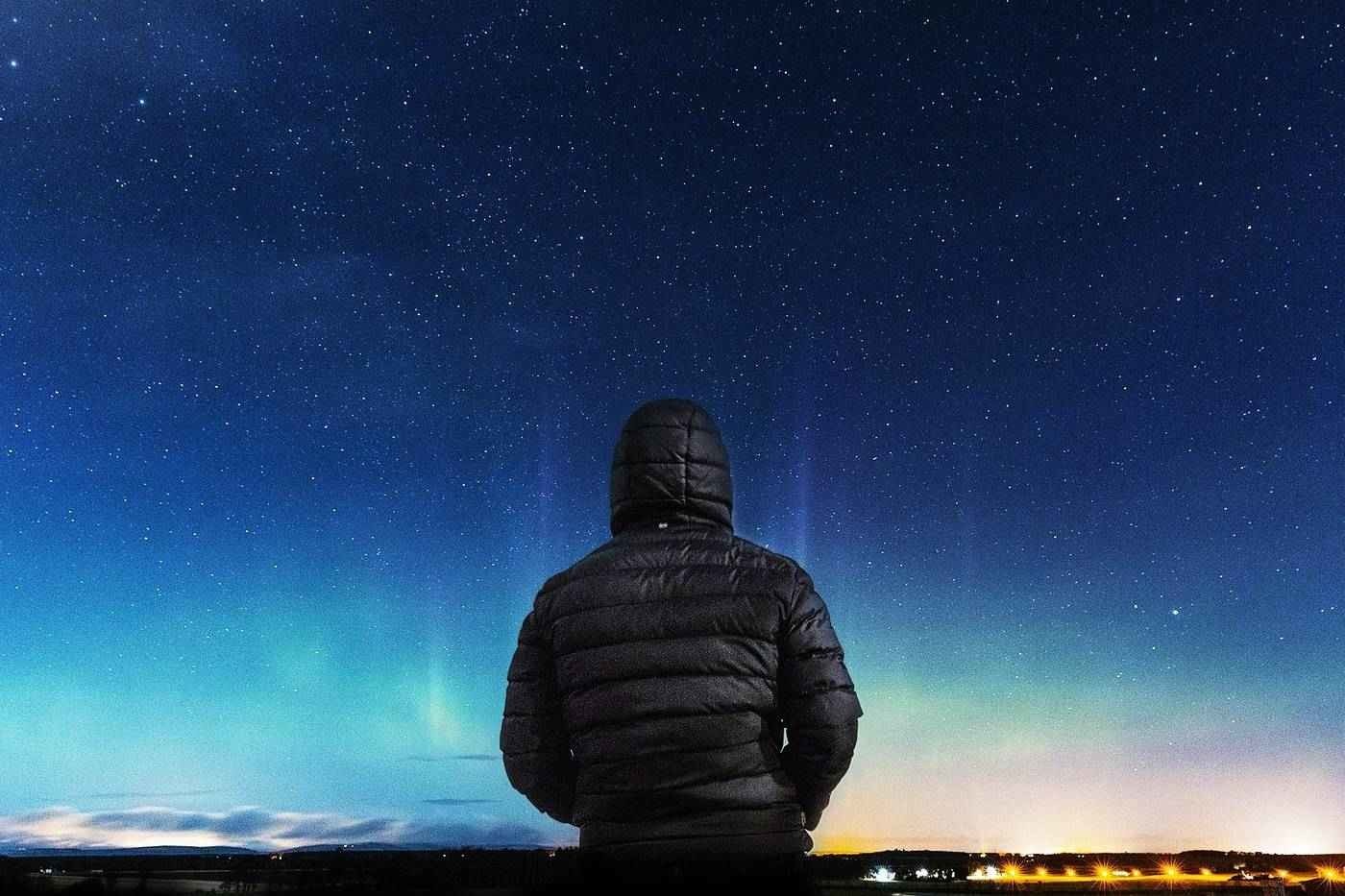 Man looking at stars at night