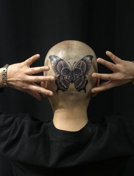 Ji's head with butterfly tattoo