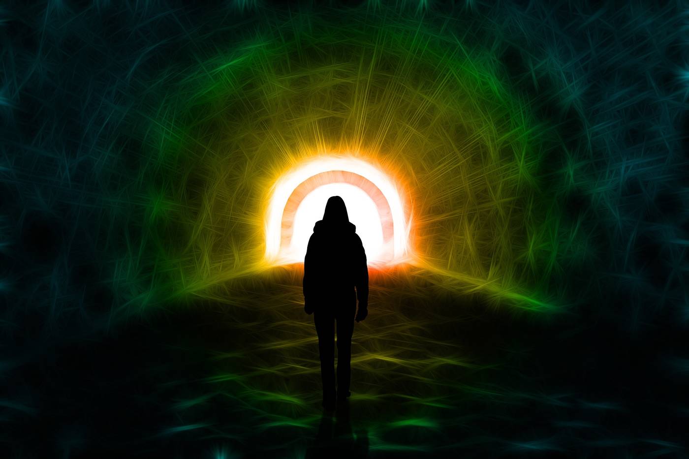 Person walking towards light at end of tunnel