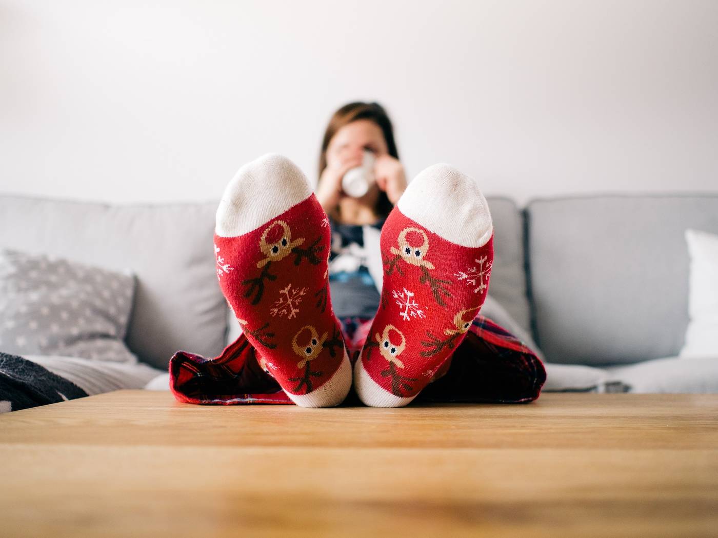 LONELINESS DURING THE HOLIDAY SEASON: 6 healthy ways to cope 21 Woman wearing Christmas socks putting feet on table