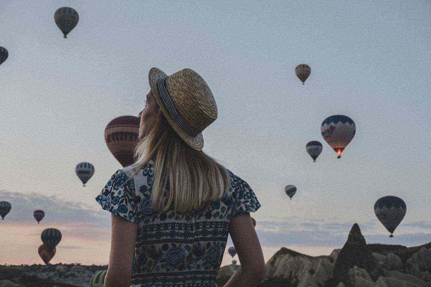 Young woman staring at hot air balloons