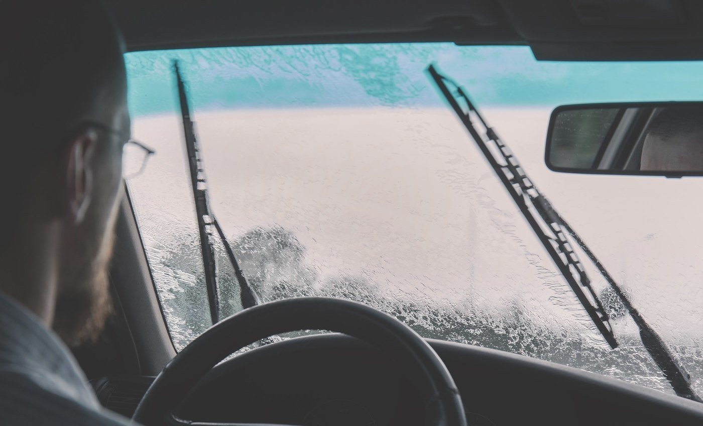 driver in car with snow on window