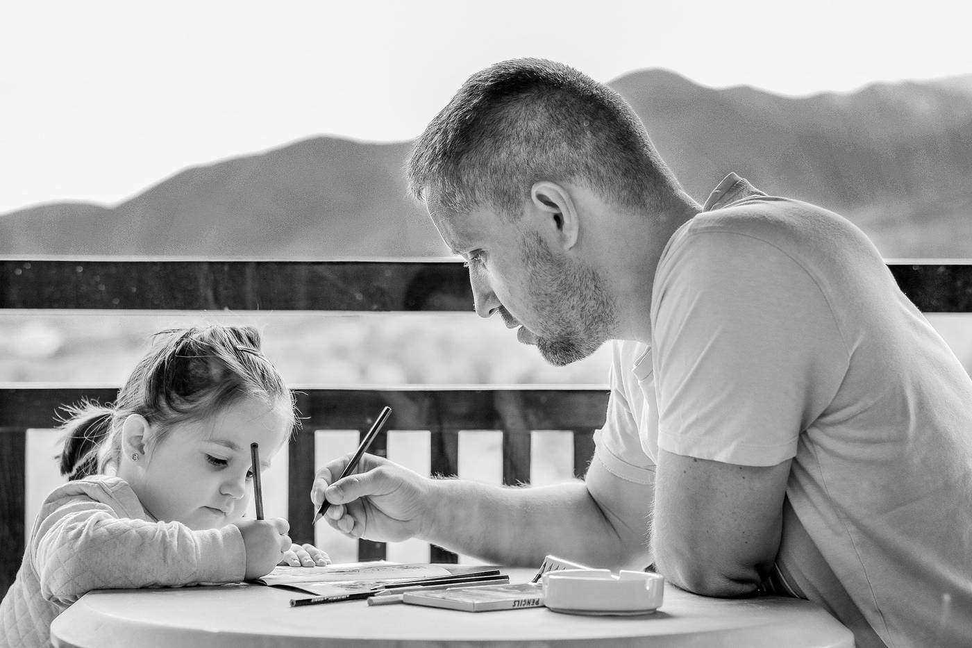 Girl drawing with father