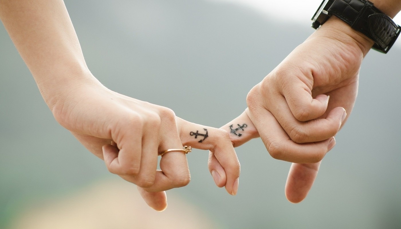 women and man linking fingers