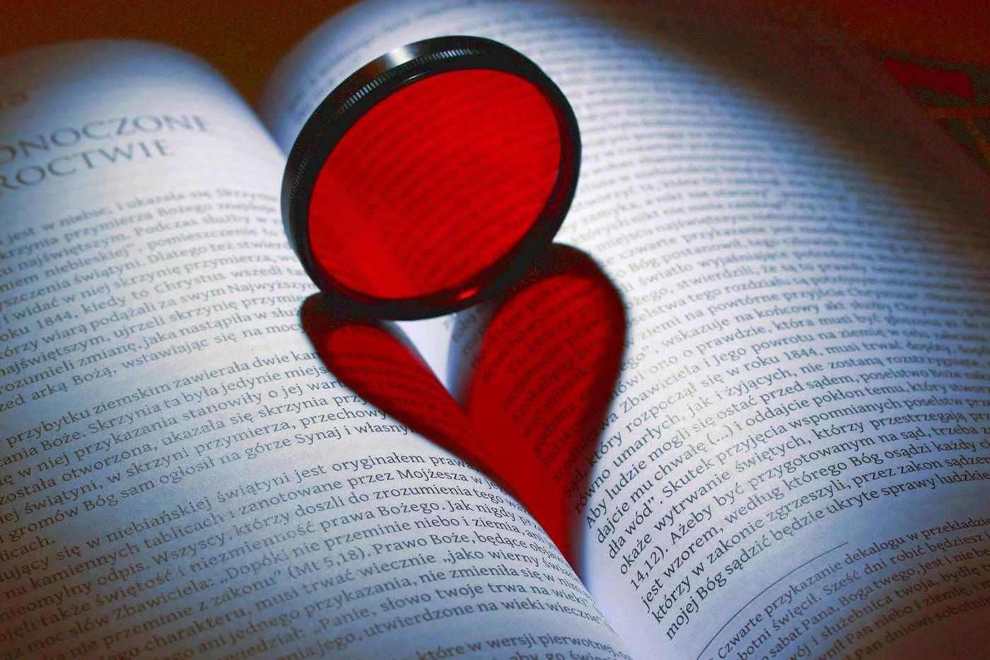 Book with magnifying glass on top