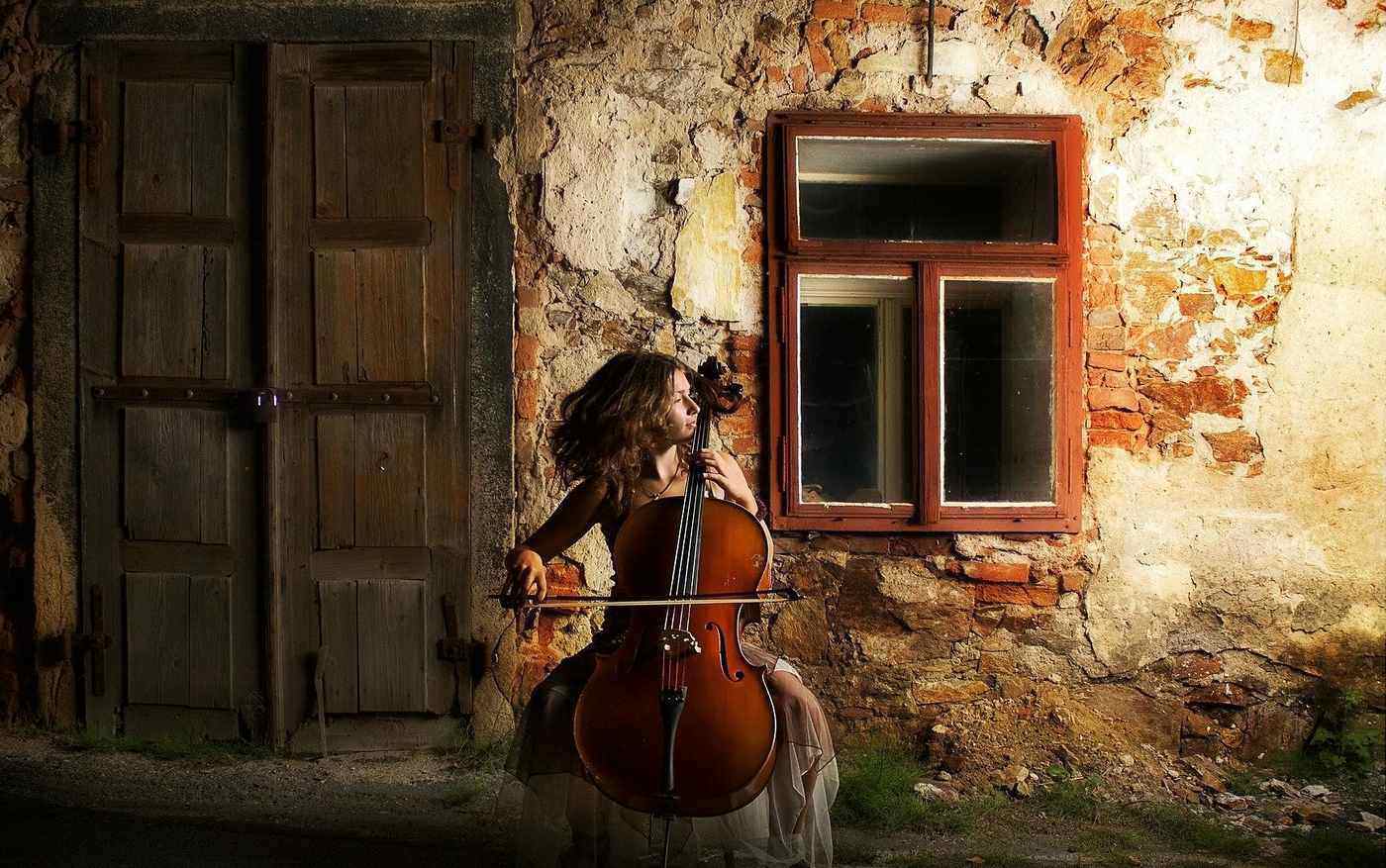 A NEW HOUSE FOR HUMANITY: Building a house that honours each soul’s dignity 14 woman playing cello in an alleyway