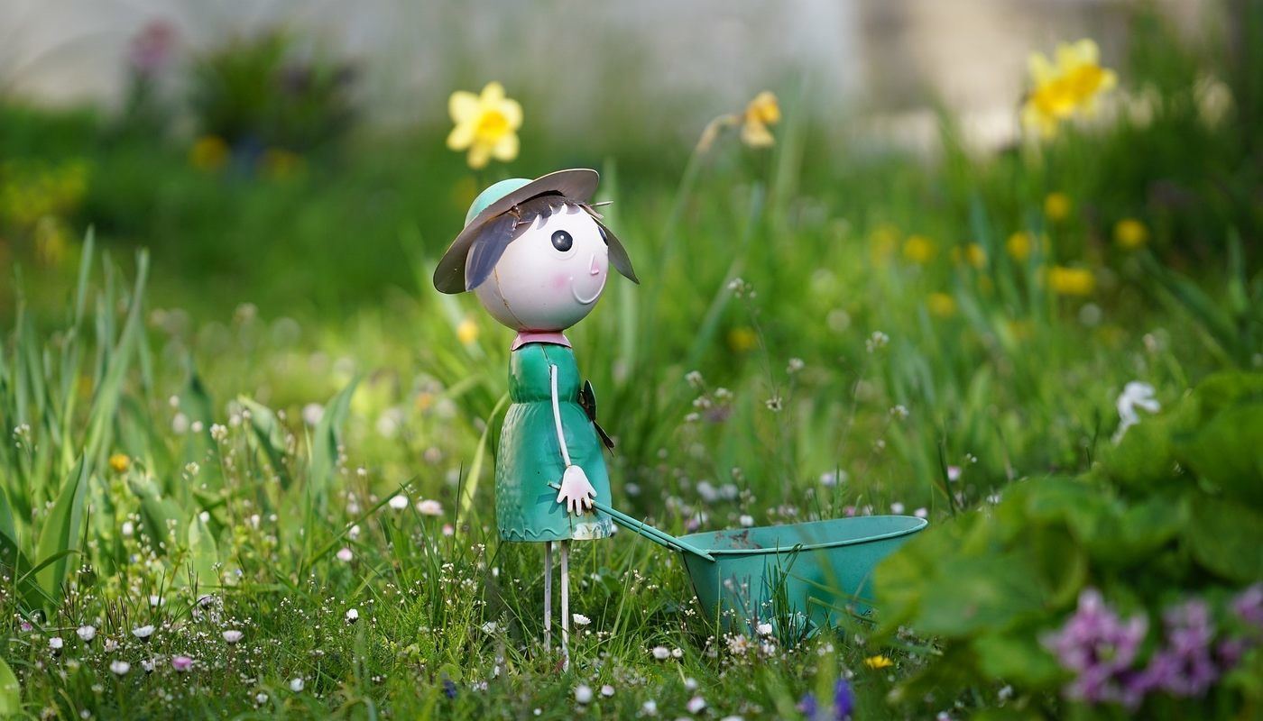 doll with wheelbarrow in garden