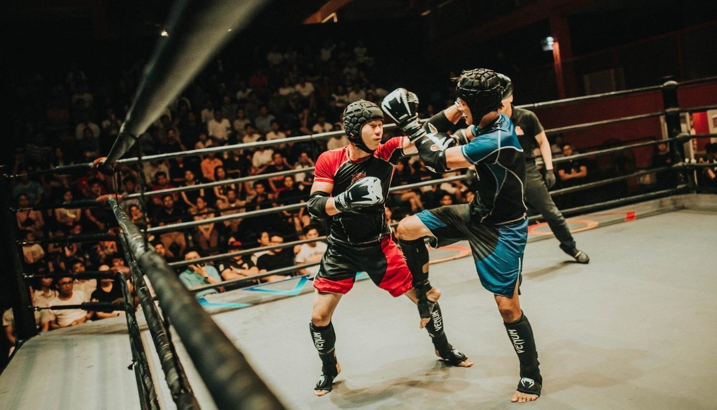 boxers in red and blue fighting in the ring