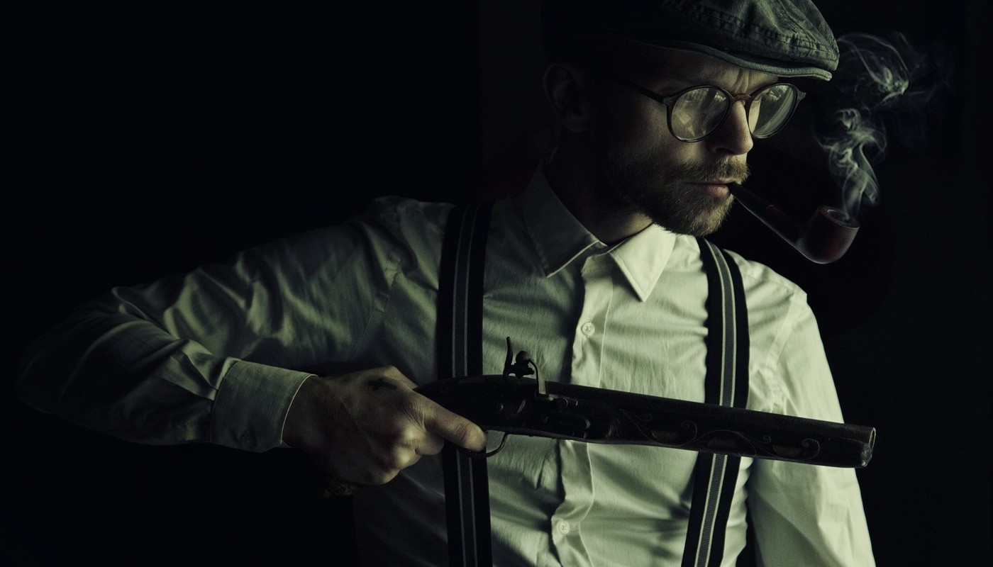 Mobster with gun looking through a window
