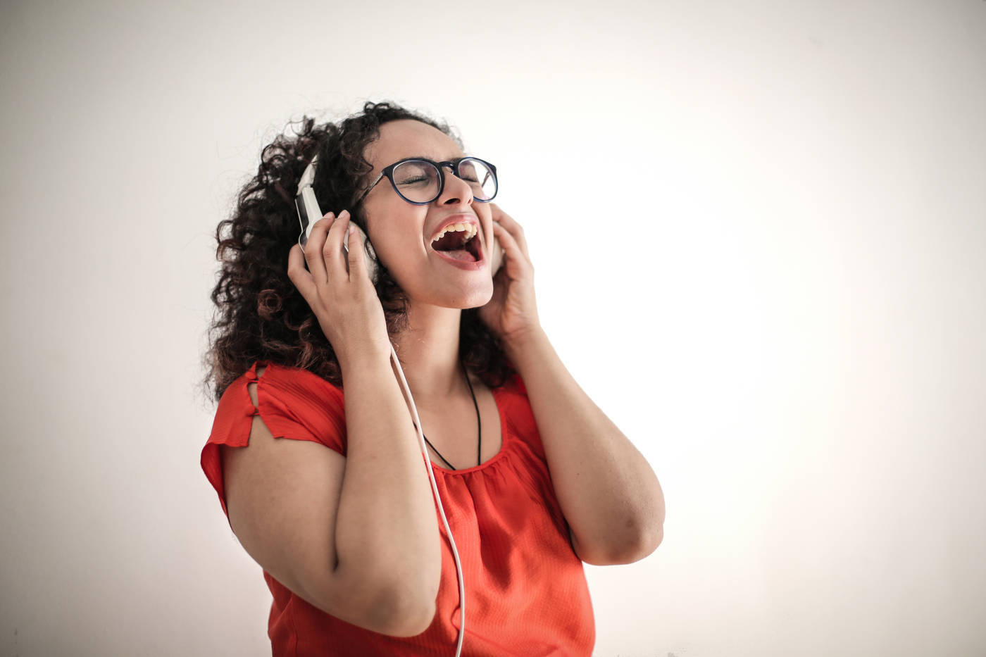 THE LANGUAGE YOUR BODY SPEAKS: Sound, rhythm and wellness 23 Woman singing with headphones on